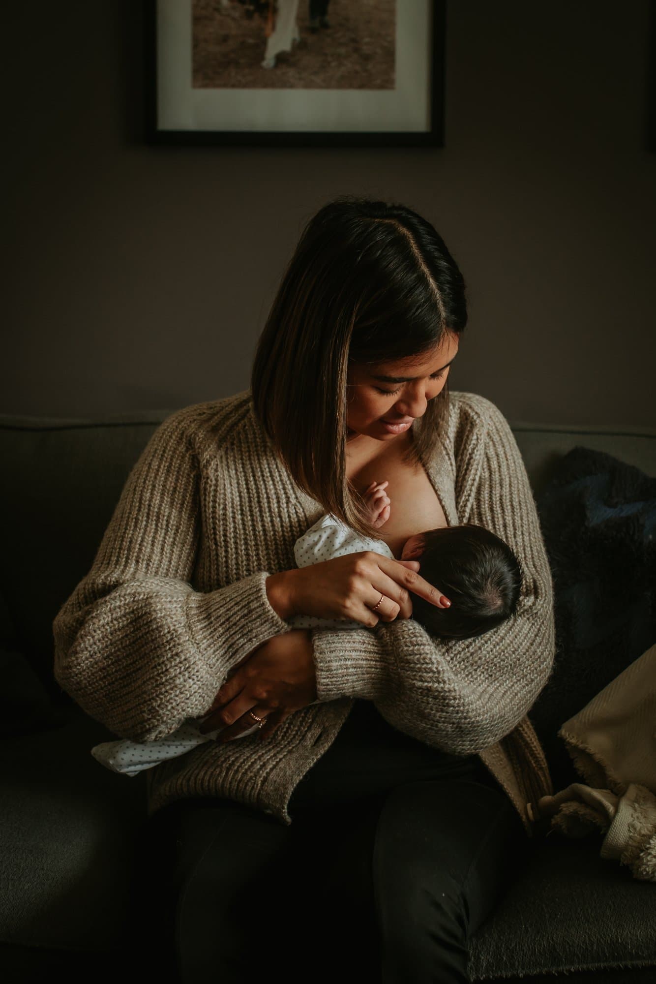Angela breastfeeding newborn at home