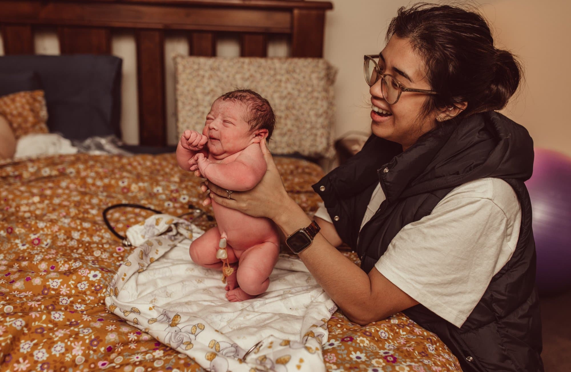 Angela checking baby's reflexes after homebirth